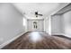 Spacious bedroom with wood floors, neutral paint, ceiling fan, and two windows at 8420 Sheridan Dr, Jonesboro, GA 30236