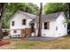 Charming two-story home with fresh exterior paint, lovely landscaping, wooden shutters, and inviting entry stairs at 8420 Sheridan Dr, Jonesboro, GA 30236