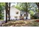 Attractive two-story house with wooden shutters, newly painted white exterior, landscaped yard, and tree shaded front at 8420 Sheridan Dr, Jonesboro, GA 30236
