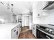 Modern kitchen with white cabinets, stainless steel appliances, large island, and wood-look floors at 8420 Sheridan Dr, Jonesboro, GA 30236