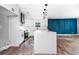 This modern kitchen is equipped with new stainless steel appliances, white cabinets, an island, and custom lighting at 8420 Sheridan Dr, Jonesboro, GA 30236