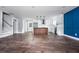 Open-concept floor plan features the kitchen with an island, stainless steel appliances, wood flooring, and dining area at 8420 Sheridan Dr, Jonesboro, GA 30236