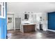 Spacious and modern kitchen featuring an island, stainless steel appliances, custom lighting, and updated flooring at 8420 Sheridan Dr, Jonesboro, GA 30236