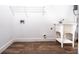 Functional laundry room with hardwood floors, a utility sink, and appliance hookups at 8420 Sheridan Dr, Jonesboro, GA 30236