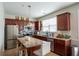 Spacious kitchen boasting stainless steel appliances, granite countertops, and a center island at 961 Pierce Ivy Ct, Lawrenceville, GA 30043