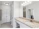 Modern bathroom featuring a granite vanity, a large mirror, and ample storage space at 10 Perimeter Summit Ne Blvd # 4243, Brookhaven, GA 30319