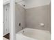 Neutral-tiled tub and shower with chrome fixtures at 10 Perimeter Summit Ne Blvd # 4243, Brookhaven, GA 30319