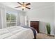 Bright bedroom features a comfortable bed, hardwood floors, and a large window at 10 Perimeter Summit Ne Blvd # 4243, Brookhaven, GA 30319