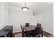 Elegant dining area with a dark wood table and chairs, complemented by modern lighting at 10 Perimeter Summit Ne Blvd # 4243, Brookhaven, GA 30319
