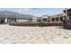 Shopping center courtyard with pavers, stone accents, trash receptacle, and partial views of shops and storefronts at 10 Perimeter Summit Ne Blvd # 4243, Brookhaven, GA 30319