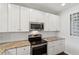 Modern kitchen featuring white cabinets, stainless appliances, and granite countertops at 10 Perimeter Summit Ne Blvd # 4243, Brookhaven, GA 30319