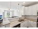 Bright kitchen featuring white cabinets, granite countertops, stainless appliances, and an open layout at 10 Perimeter Summit Ne Blvd # 4243, Brookhaven, GA 30319