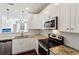 Well-lit kitchen with white cabinets, granite counters, stainless steel appliances and breakfast bar at 10 Perimeter Summit Ne Blvd # 4243, Brookhaven, GA 30319