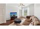 Cozy living room with hardwood floors, ceiling fan, plush sofa, and a flat-screen TV at 10 Perimeter Summit Ne Blvd # 4243, Brookhaven, GA 30319