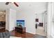 Open-concept living area with hardwood floors, flat-screen TV, and view into bedroom at 10 Perimeter Summit Ne Blvd # 4243, Brookhaven, GA 30319