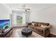 Cozy living room with hardwood floors, neutral colors, a plush sofa, and a modern TV at 10 Perimeter Summit Ne Blvd # 4243, Brookhaven, GA 30319
