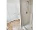 Clean bathroom with walk-in shower, tile floor, and classic white door offering a refreshing and functional space at 145 Shadowbrook Trce, Covington, GA 30016