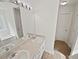 Bathroom featuring double sinks, white cabinets, and a large mirror at 145 Shadowbrook Trce, Covington, GA 30016