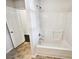 Clean bathroom features a tub-shower combo with white tile and a convenient grab bar, offering safety and accessibility at 145 Shadowbrook Trce, Covington, GA 30016