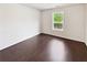 Inviting bedroom features hardwood floors, a bright window, and neutral walls creating a relaxing and comfortable space at 145 Shadowbrook Trce, Covington, GA 30016