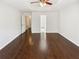 Bright, spacious bedroom features wood floors, tray ceiling with fan, and neutral walls ready for personalization at 145 Shadowbrook Trce, Covington, GA 30016