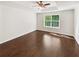 Bedroom with large window, hard wood floors, tray ceiling and recessed lighting at 145 Shadowbrook Trce, Covington, GA 30016