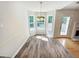 Bright dining area with bay windows and a chandelier, features elegant wood-look flooring and natural light at 145 Shadowbrook Trce, Covington, GA 30016