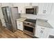 New stainless steel appliances, granite countertops and white cabinets at 145 Shadowbrook Trce, Covington, GA 30016