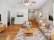 Bright living room with wood floors, ceiling fan, neutral colors and plenty of natural light at 145 Shadowbrook Trce, Covington, GA 30016