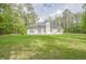 Spacious backyard with lush greenery and a view of the home's back exterior at 2180 Briarwood Ct, Villa Rica, GA 30180