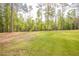 This property features a lush green backyard and mature trees at 2180 Briarwood Ct, Villa Rica, GA 30180