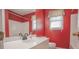 The bright bathroom offers a single sink vanity and decorative neutral window coverings at 2180 Briarwood Ct, Villa Rica, GA 30180