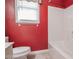 Bright bathroom offers a single window and a shower over tub combination at 2180 Briarwood Ct, Villa Rica, GA 30180