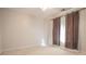 This bedroom offers light walls, neutral carpet, and a bright window at 2180 Briarwood Ct, Villa Rica, GA 30180
