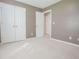 This bedroom features neutral walls, white carpet, and a double door closet at 2180 Briarwood Ct, Villa Rica, GA 30180