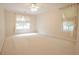 Spacious bedroom featuring neutral carpet, a ceiling fan, and a bright window with sheer curtains at 2180 Briarwood Ct, Villa Rica, GA 30180