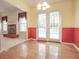 Bright dining area features hardwood floors, a modern lighting fixture and french door access to the backyard at 2180 Briarwood Ct, Villa Rica, GA 30180