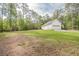 Spacious lot with lush greenery surrounding a charming single-story home with an attached garage at 2180 Briarwood Ct, Villa Rica, GA 30180