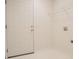 Laundry room featuring white walls, tile floors and a 6 panel white interior door at 2180 Briarwood Ct, Villa Rica, GA 30180