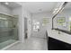 Bright bathroom with a glass shower, dual sinks, a large mirror, and white countertops at 2534 Norwood Park Xing, Atlanta, GA 30340