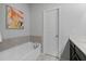 Modern bathroom with a soaking tub, a tile backsplash, and a clean, contemporary design at 2534 Norwood Park Xing, Atlanta, GA 30340