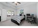 Inviting bedroom with a tray ceiling, comfortable bed, and large window offering natural light at 2534 Norwood Park Xing, Atlanta, GA 30340