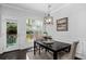 Bright dining area with a modern chandelier and natural light pouring through the window at 2534 Norwood Park Xing, Atlanta, GA 30340