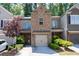 Charming townhome with brick facade, attached garage, and inviting front garden at 2534 Norwood Park Xing, Atlanta, GA 30340
