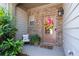 Inviting front porch with a cozy seating area and a decorative potted fern at 2534 Norwood Park Xing, Atlanta, GA 30340