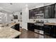 Modern kitchen features stainless steel appliances, granite countertops, and sleek black cabinetry at 2534 Norwood Park Xing, Atlanta, GA 30340