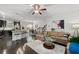 Open-concept living room with kitchen, comfortable seating, and hardwood floors at 2534 Norwood Park Xing, Atlanta, GA 30340