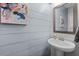 Stylish powder room featuring shiplap walls, a pedestal sink, and contemporary decor at 2534 Norwood Park Xing, Atlanta, GA 30340