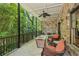 Secluded back porch with stone accents, cozy seating, a firepit, and wooded views at 3113 Lenox Ne Rd # 6, Atlanta, GA 30324