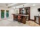 Entertainer's basement bar with custom cabinetry, seating, wine storage, and walkout to yard at 3113 Lenox Ne Rd # 6, Atlanta, GA 30324